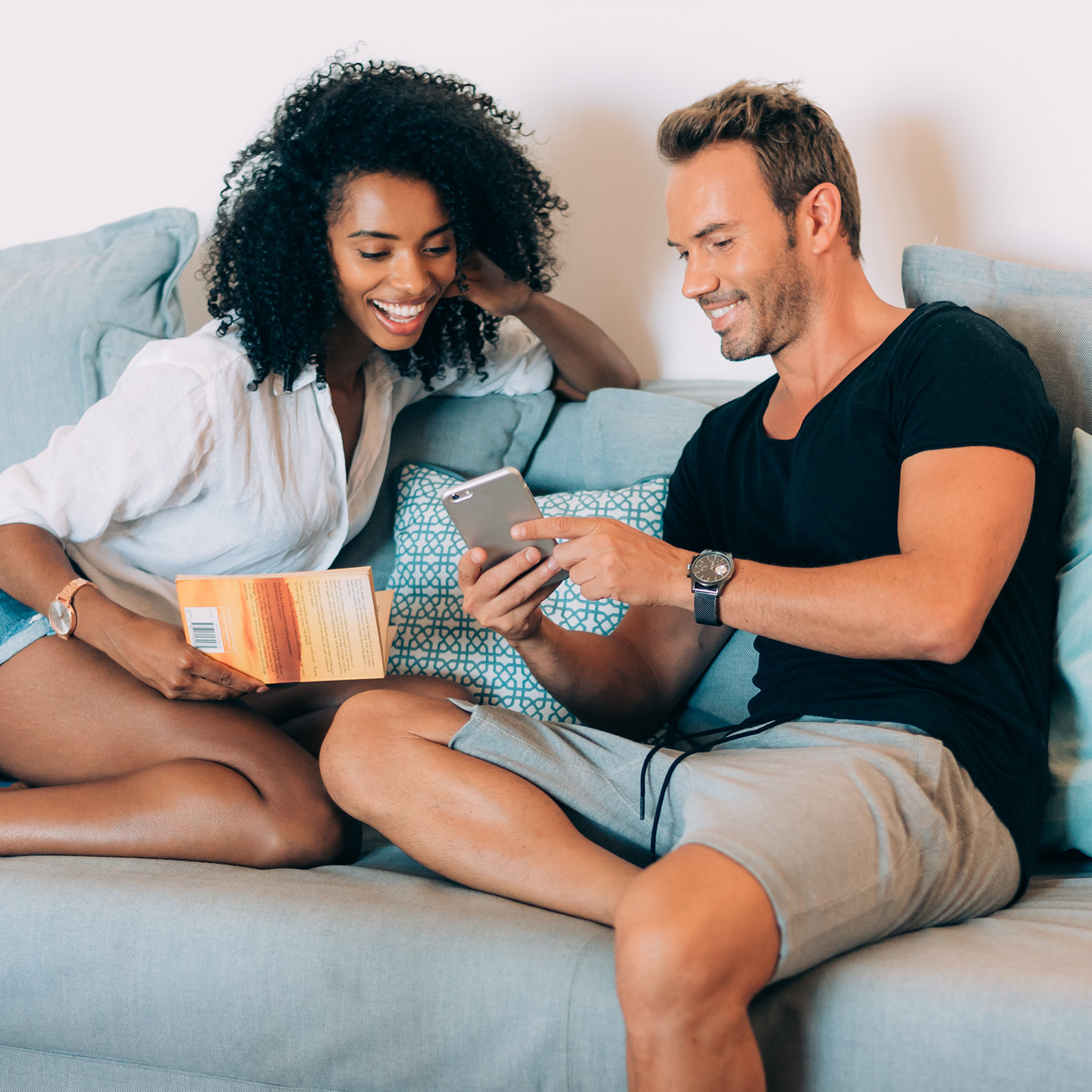 couple on sofa looking at phone